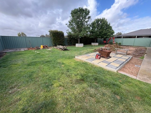 Existing uneven and patchy backyard lawn before landscaping in Kialla.