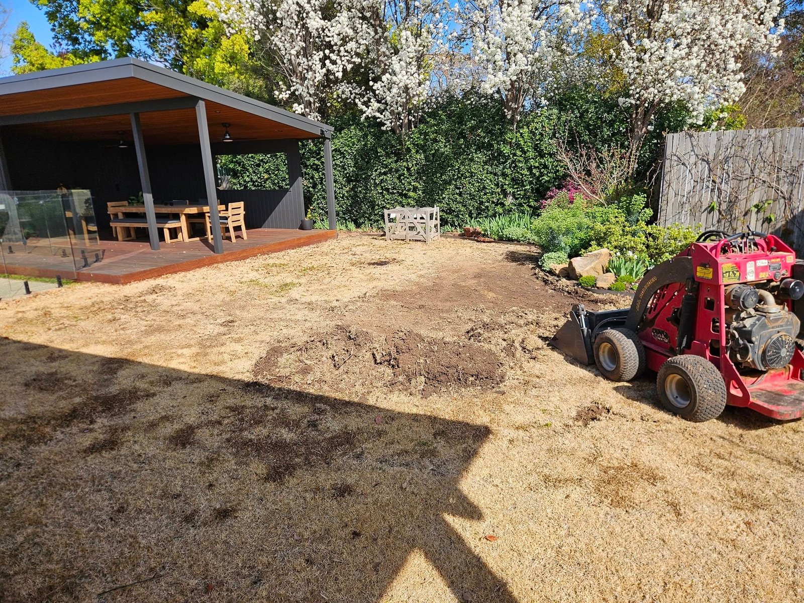 Existing backyard lawn removed during site preparation for a Shepparton landscaping project.