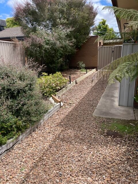 Existing side garden, rock walkway and old retaining wall before the Shepparton garden renovation.