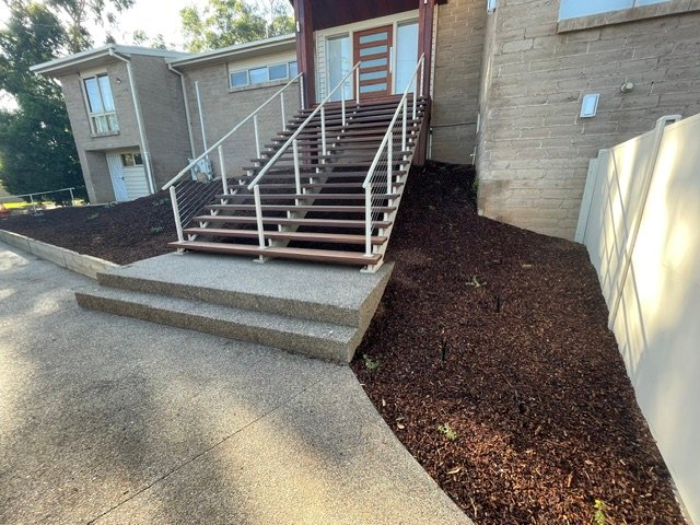 Completed mulched garden bed beside the front steps of a Shepparton home.