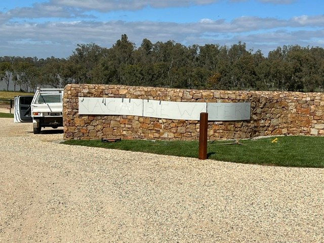 Entrance signage set-out and installation in progress.