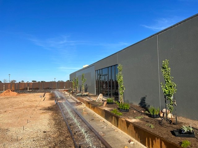 The water feature and surrounding gardens taking shape during installation.