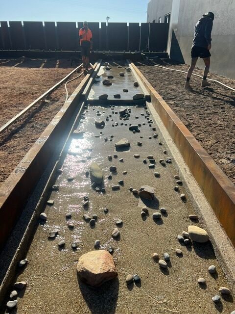 Feature stones being arranged through the rill befor