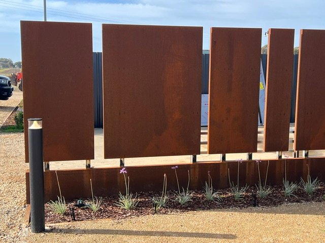 Corten steel screening adds warmth and a strong architectural finish to the landscape.