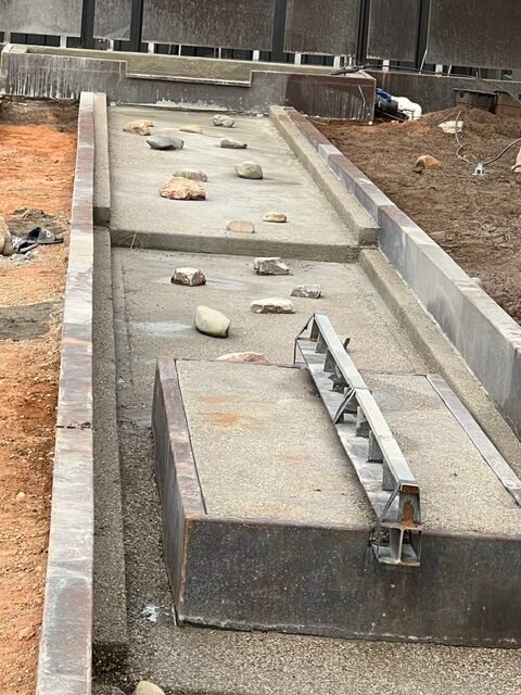 Upper basin and cascade details taking shape before the water system was commissioned.