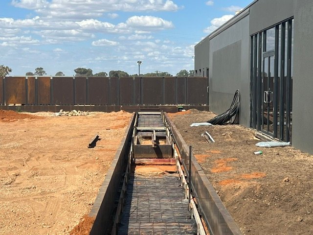 Structural preparation for the custom linear water feature.