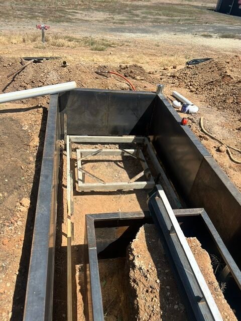Internal steel framing and service preparation inside the fountain basin.