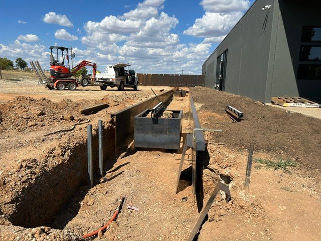 Excavation and steel installation during the early water-feature build.