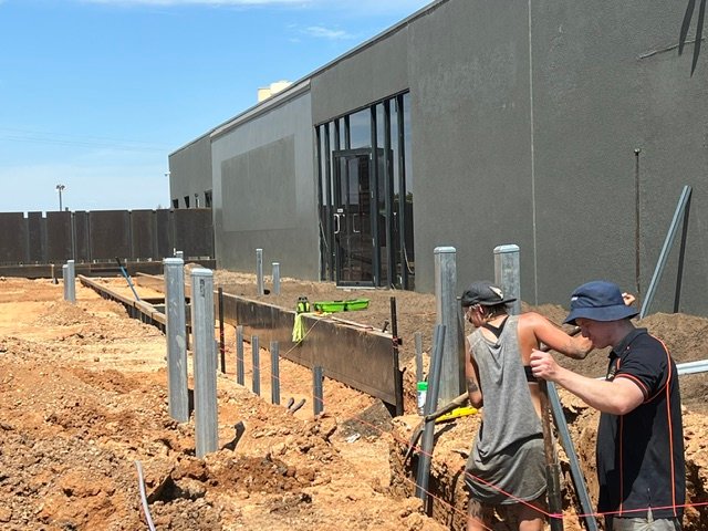 Steel supports being positioned and checked during construction.