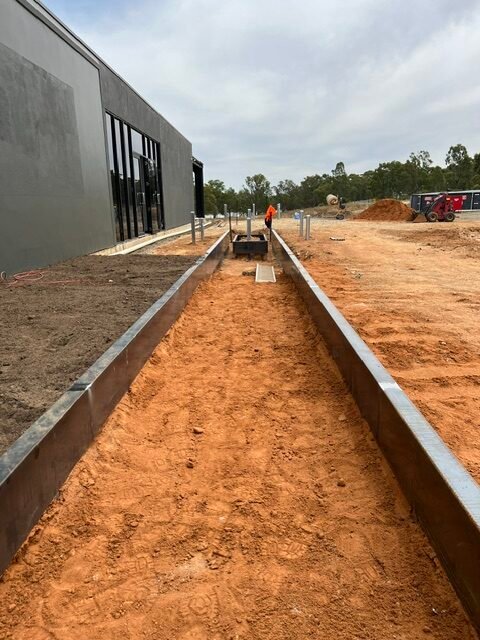 The water-feature channel after excavation and initial steel installation.