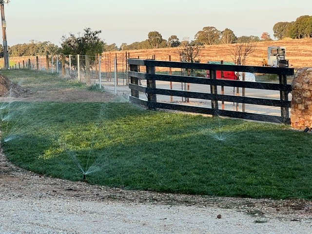 Newly installed turf being watered during irrigation testing.