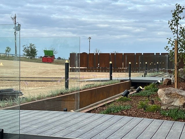 Water, planting and Corten steel brought together beside the outdoor deck.